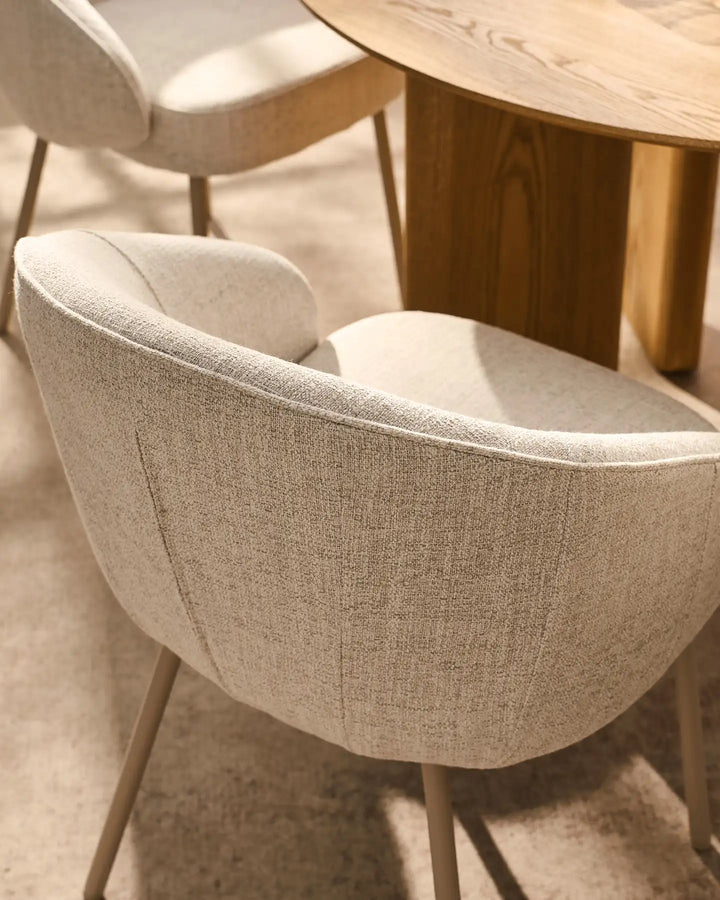 Detail of the Elowen beige linen dining chair featuring a generously padded curved backrest for lasting comfort and support