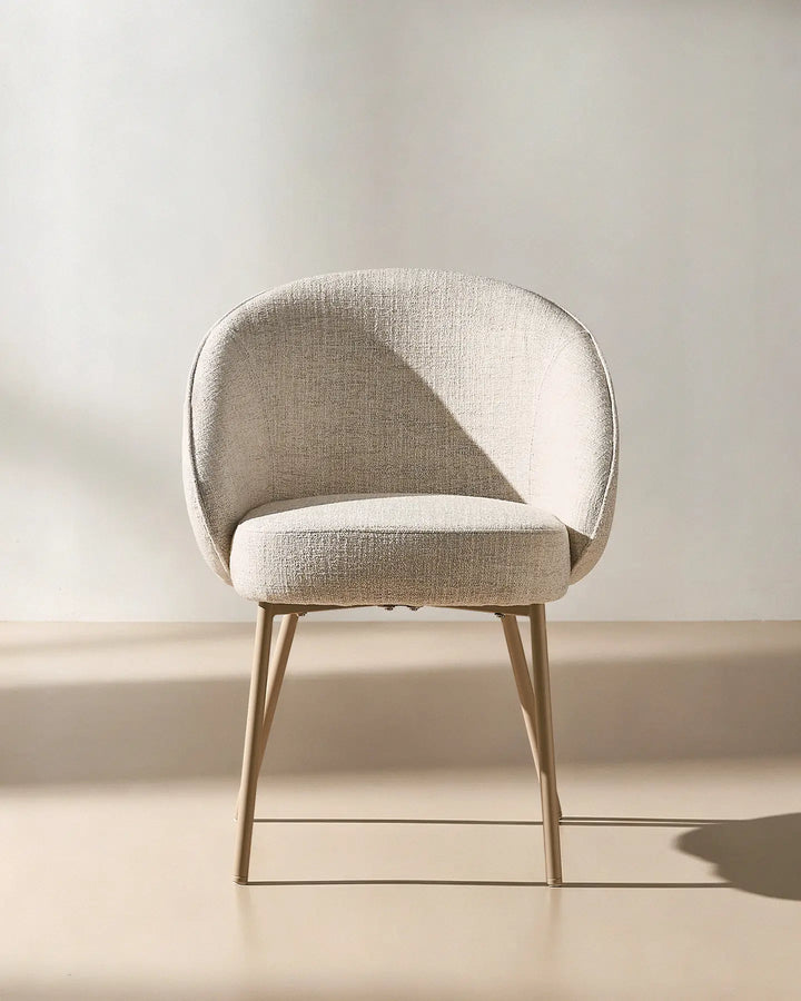 Front view of the Elowen beige linen dining chair with thick padded seat, curved backrest and upholstered armrests