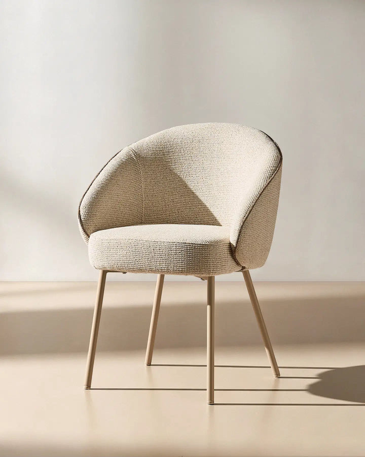 45 degree view of the Elowen cream and brown chenille dining chair highlighting its thick padded comfort and elegant profile