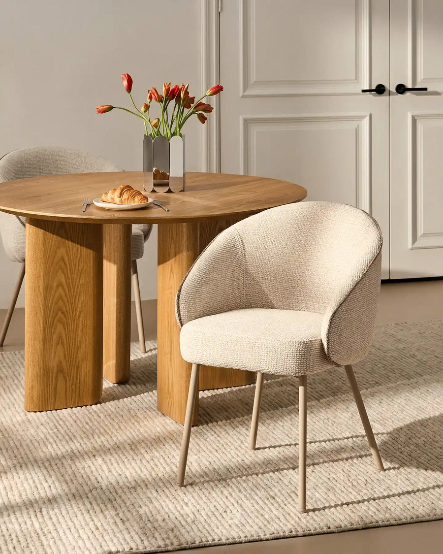 Top view of the Elowen cream and brown chenille dining chair beside a dining table highlighting its thick padded comfort