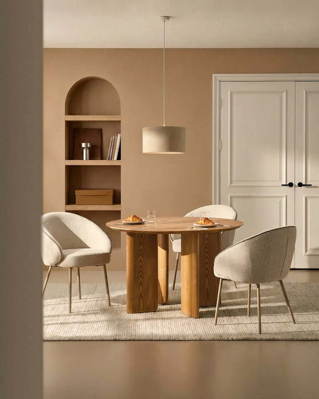 Three Elowen cream and brown chenille dining chairs around a dining table with thick padded comfort and modern Scandinavian style