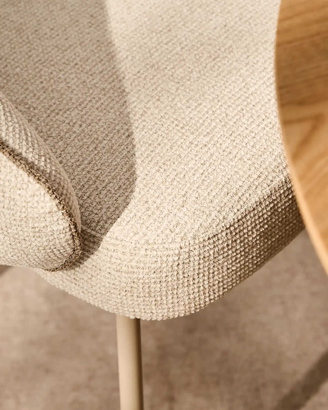 Close-up of the soft chenille upholstery on the Elowen cream and brown dining chair with a rich textured finish