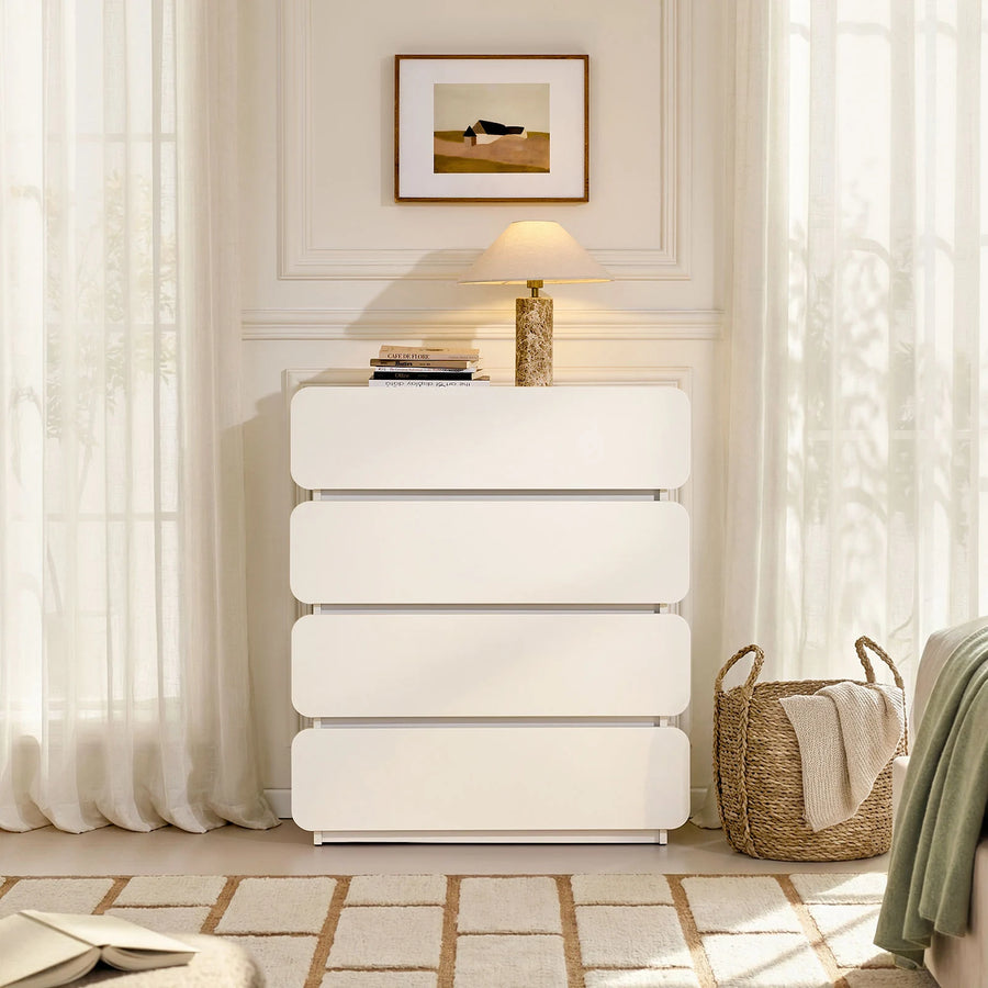 The Ennis 4 Drawer Chest of Drawers is placed beside the bed, creating a clean and modern bedroom look.