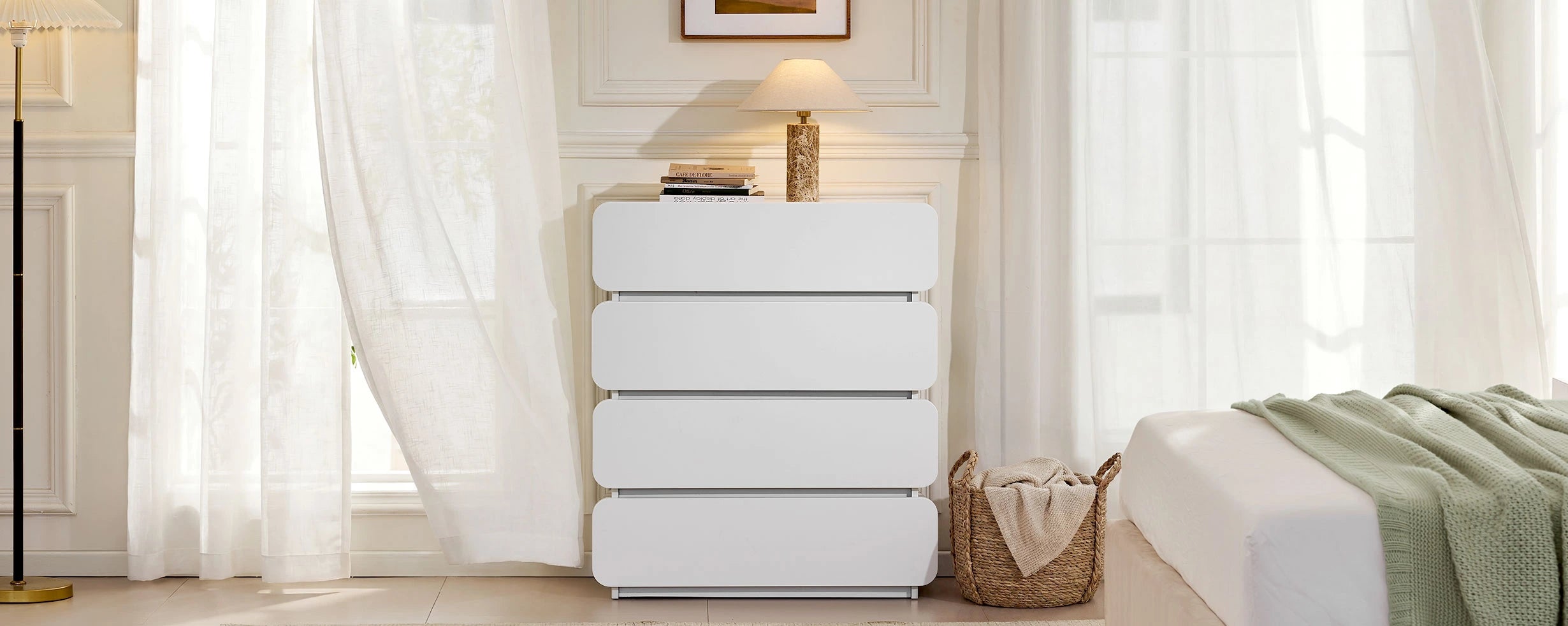 Ennis 4 Drawer Chest of Drawers placed beside the bed, creating a clean and modern bedroom look.