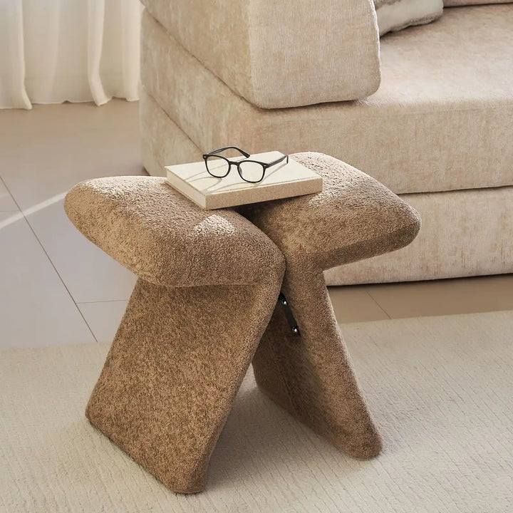 Faye Teddy Brown Accent Stool styled beside a sofa in a modern living room, serving as a practical side accent