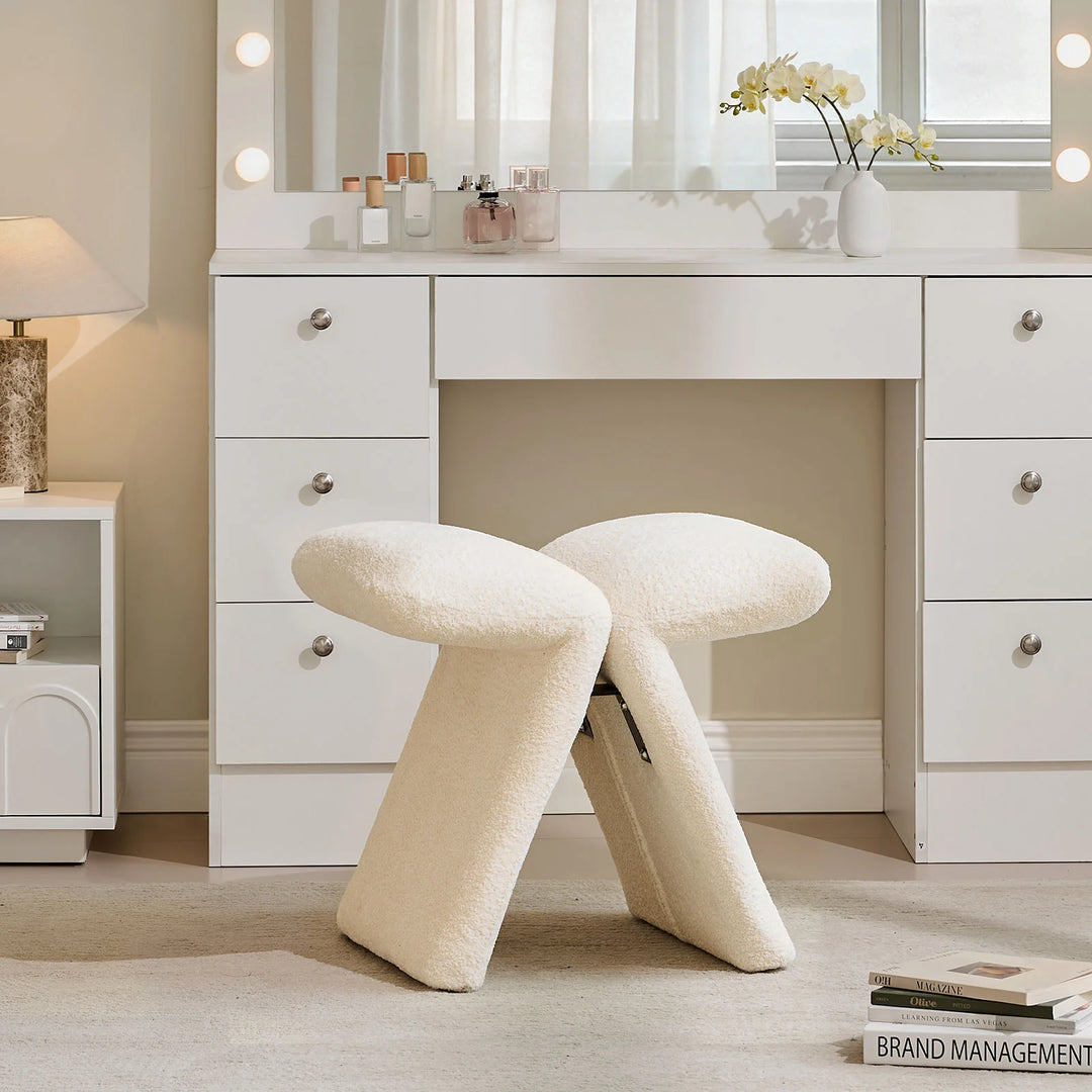 Faye warm white Accent Stool used as a vanity stool in a bedroom, positioned in front of a white dressing table.
