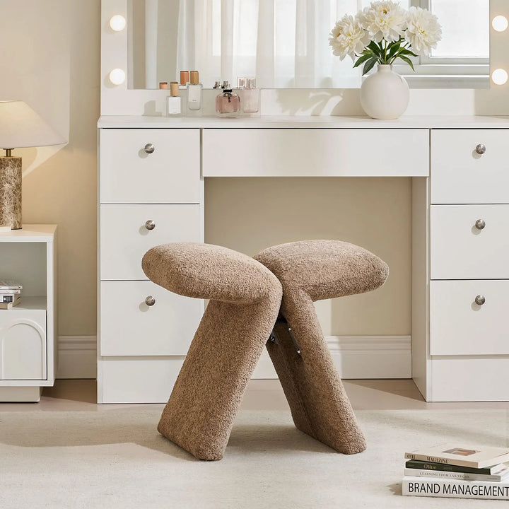Faye Teddy Brown Accent Stool used as a vanity stool in a bedroom, positioned in front of a white dressing table