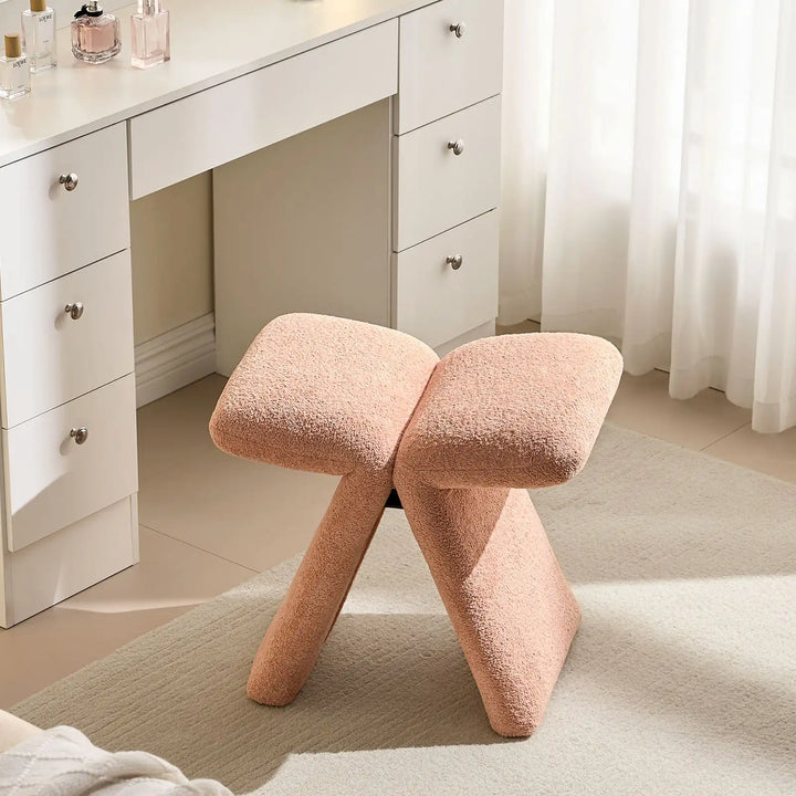 Top view of the Faye Warm Blush Accent Stool used as a vanity stool, showcasing its butterfly-shaped seat