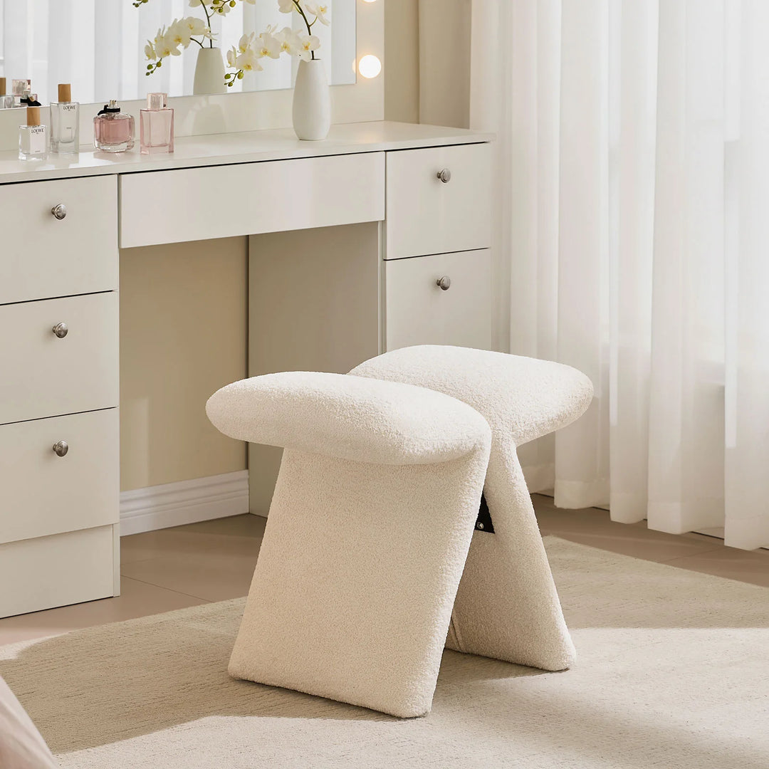 Faye warm white Accent Stool used as a vanity stool in a bedroom, positioned in front of a white dressing table.