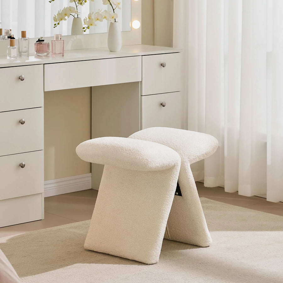 Faye warm white Accent Stool used as a vanity stool in a bedroom, positioned in front of a white dressing table.