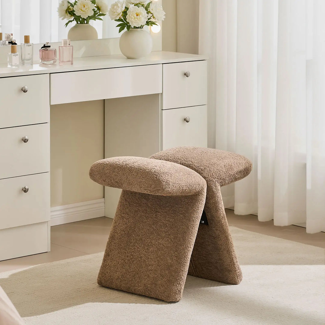 Faye Teddy Brown Accent Stool styled as a bedroom vanity stool in front of a white dressing table