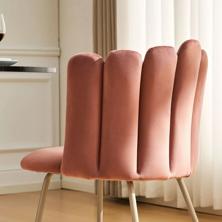 Close-up of pink Fleur Fabric side chair with petal backrest stitching detail.