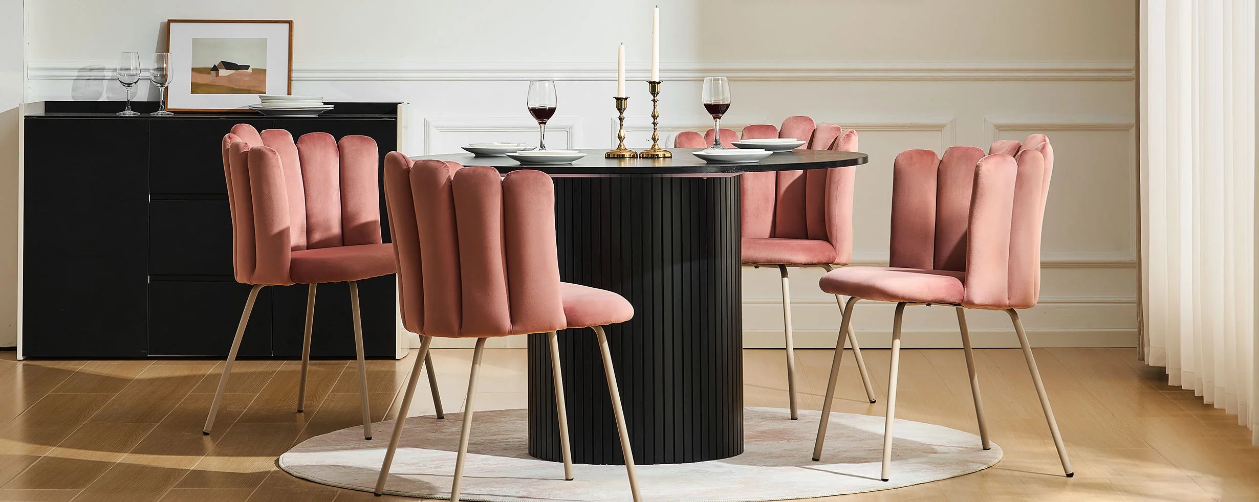 Bright dining room featuring four Fleur 
pink Fabric dining chairs around a round table.
