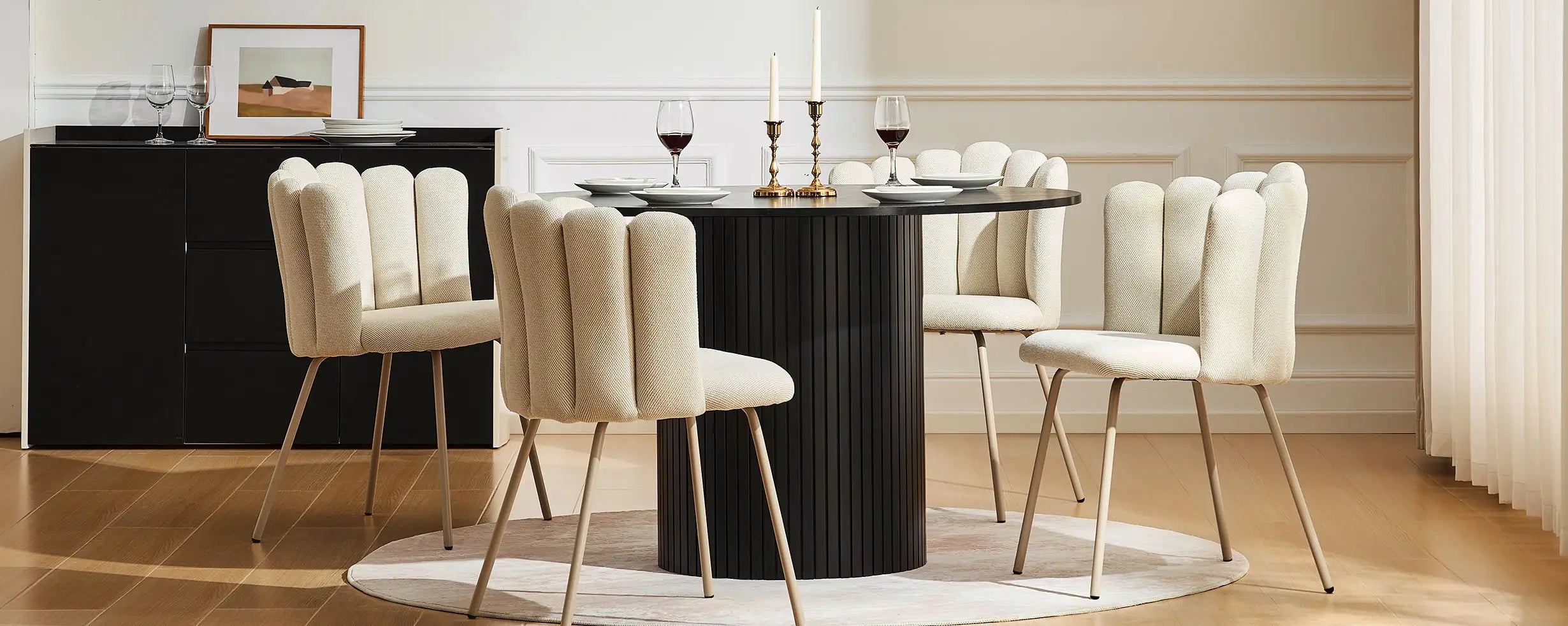 Bright dining room featuring four Fleur Cream Fabric dining chairs around a round table.