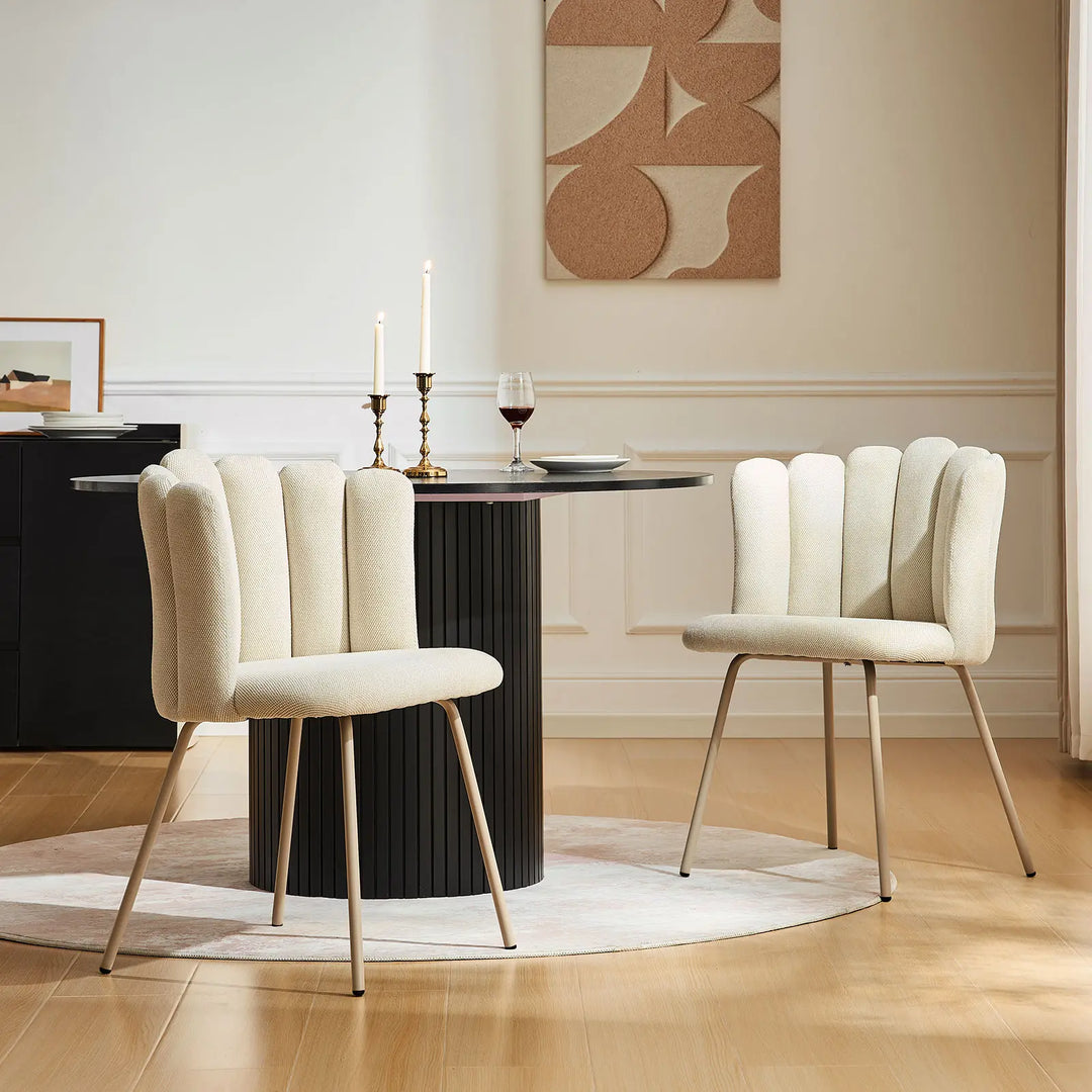 Pair of Fleur Cream Fabric dining chairs adding style to a small dining space.