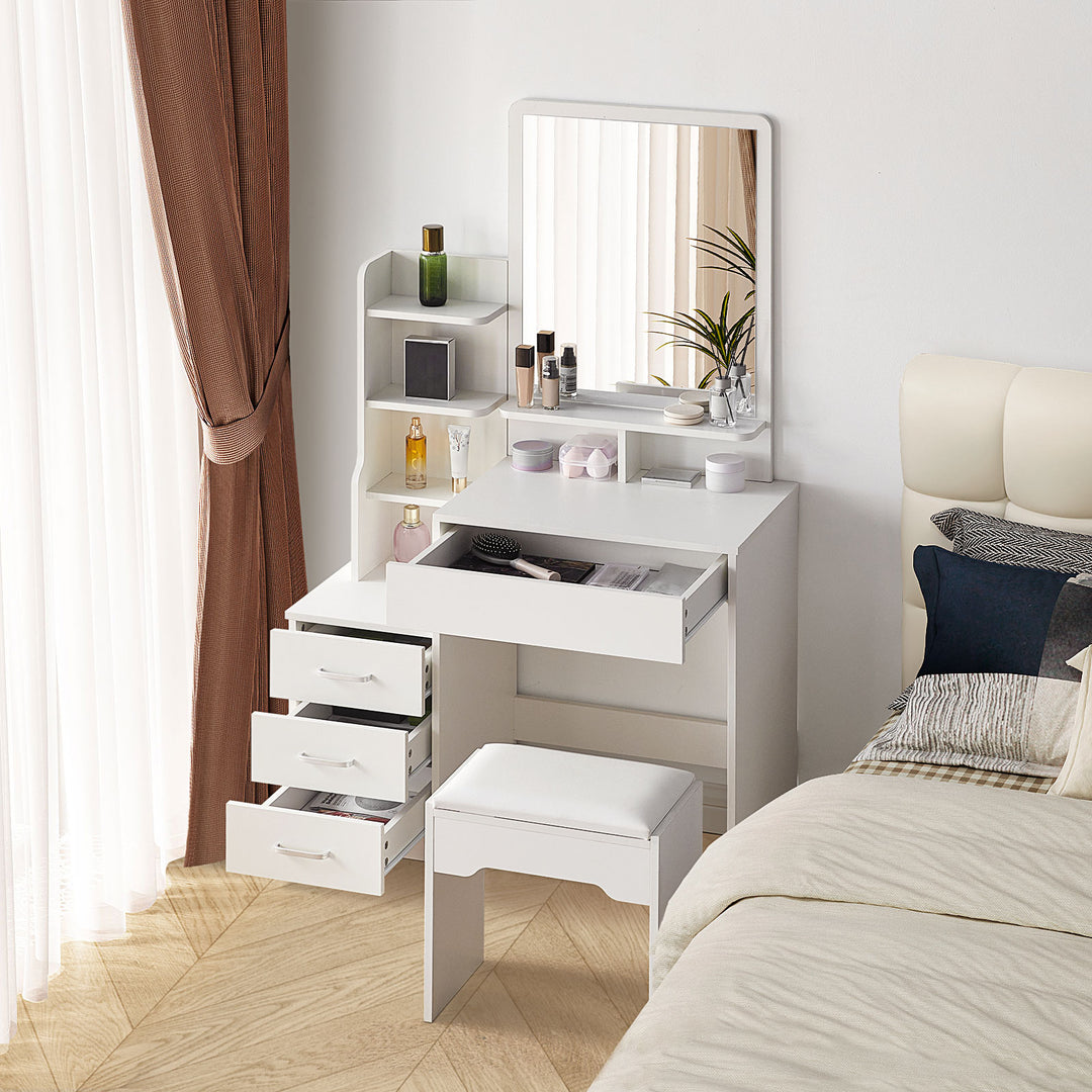 The side view of the white dressing table set, with a mirror, a 3-drawer cabinet, a big drawer under the tabletop, several shelves, and a stool, with all drawers open, in a bright bedroom.