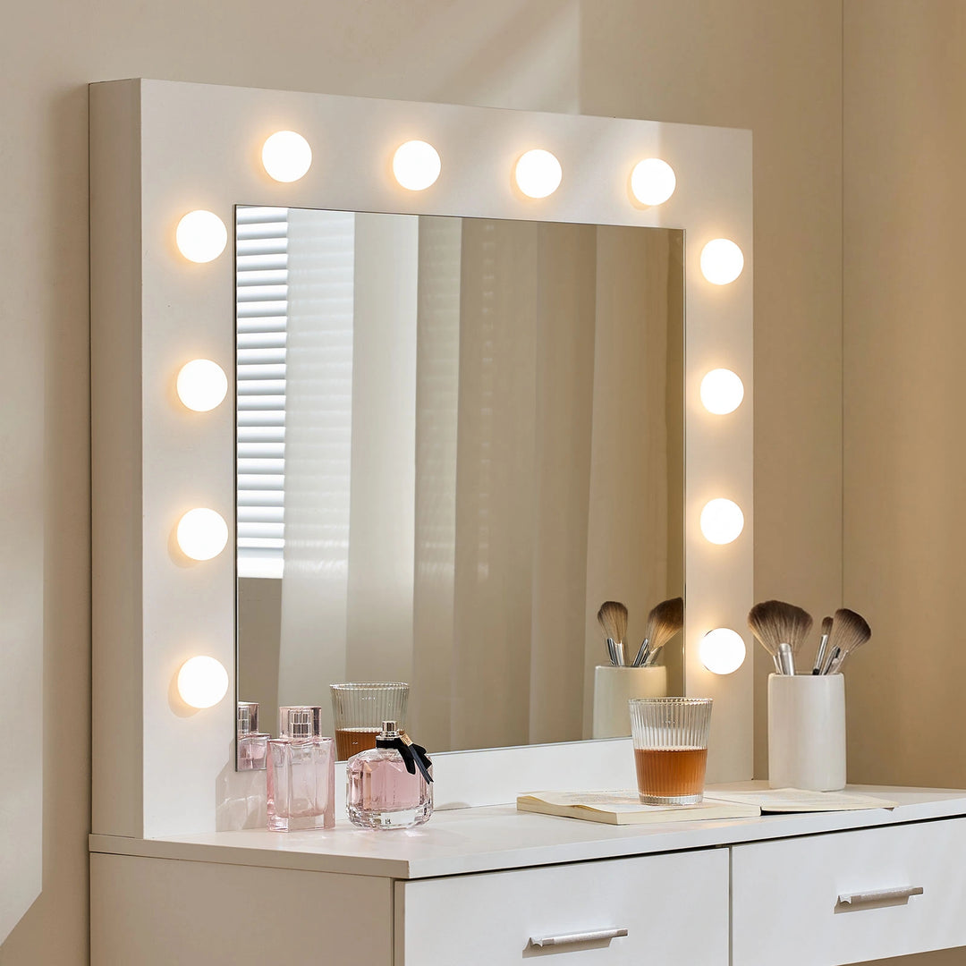 Illuminated mirror of the Hollywood White Dressing Table Set with lights turned on around the frame