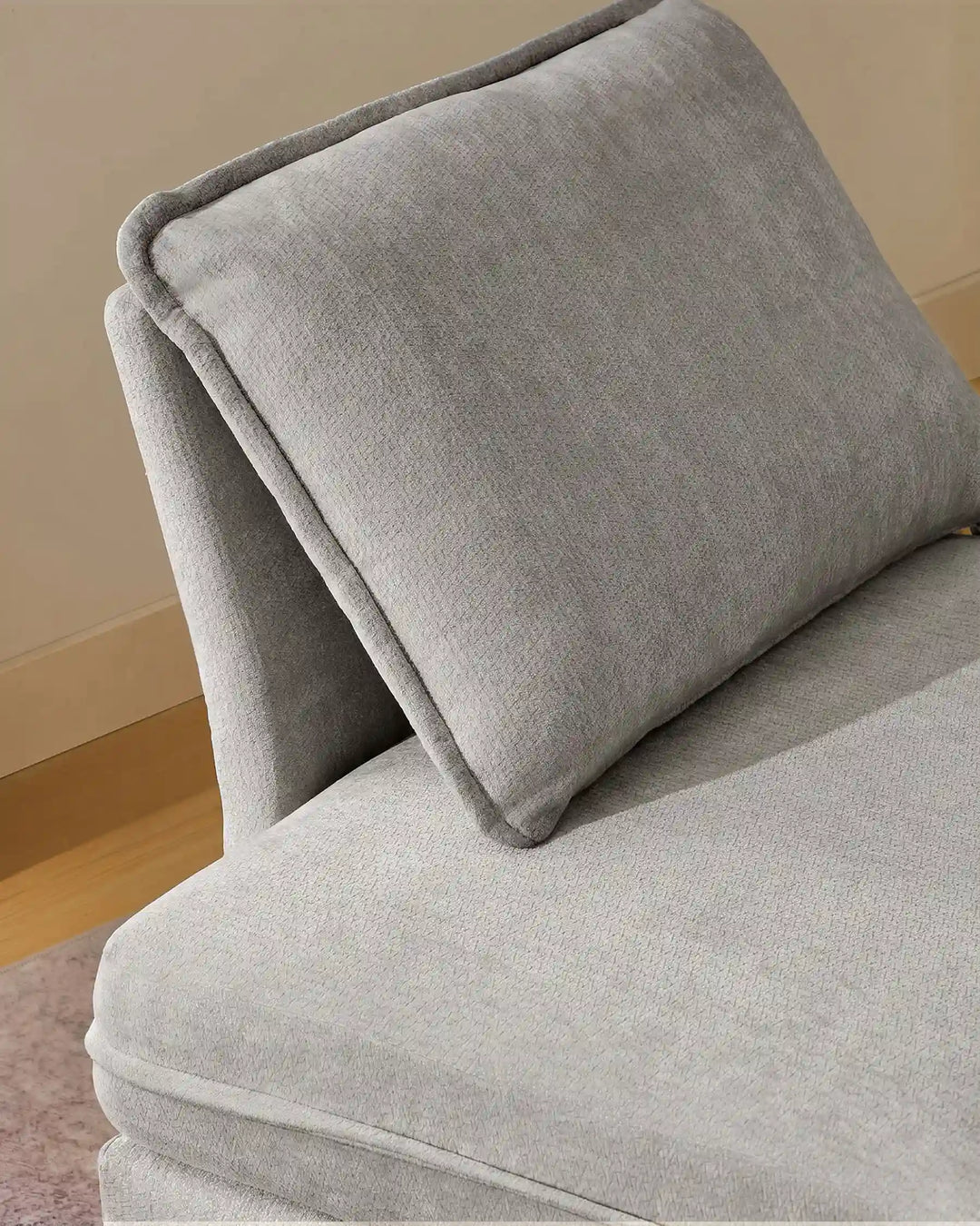 Close-up of grey Hudson modular sofa (left) backrest cushions showing plush comfort and soft chenille fabric