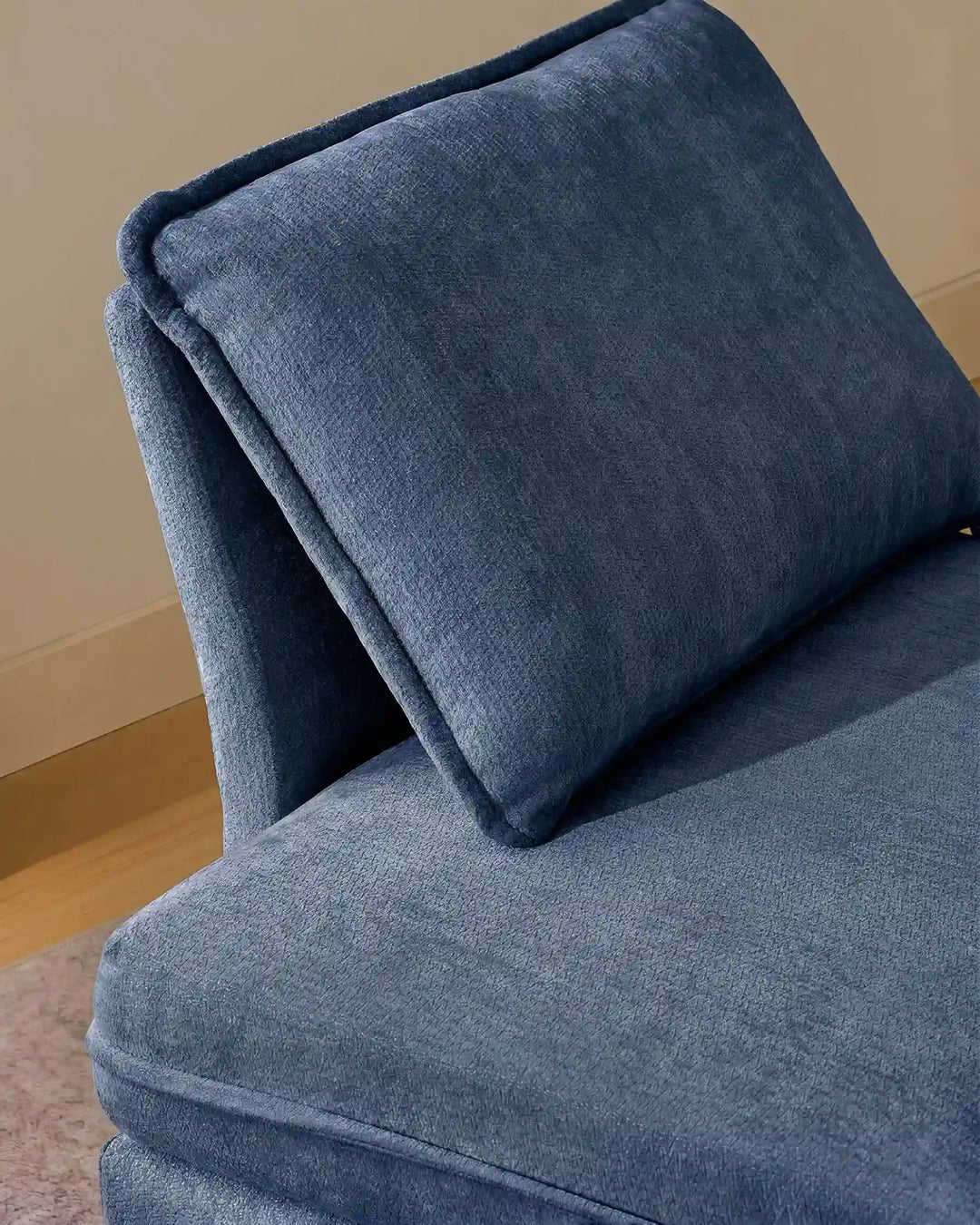 Close-up of blue Hudson modular sofa (left) backrest cushions showing plush comfort and soft chenille fabric