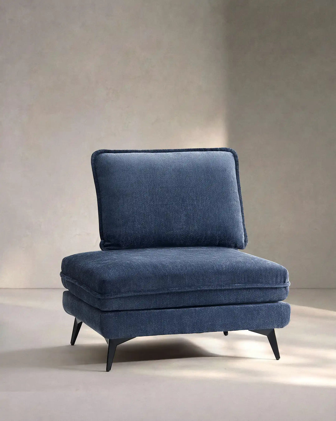 Hudson blue modular sofa (left) on white background showing side view