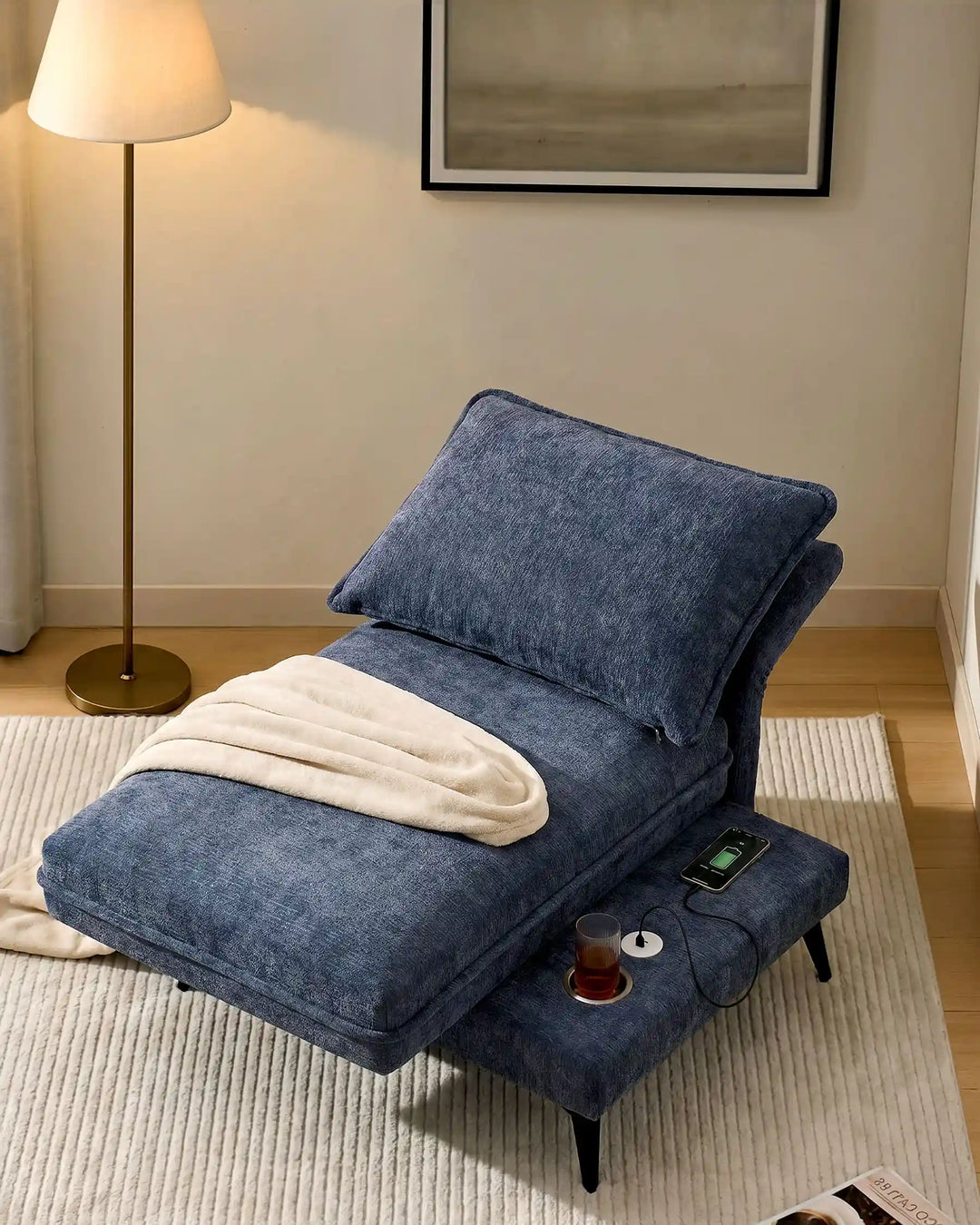 Hudson blue modular sofa (right) with fully reclined backrest, transforming into a lounge sofa in living room corner
