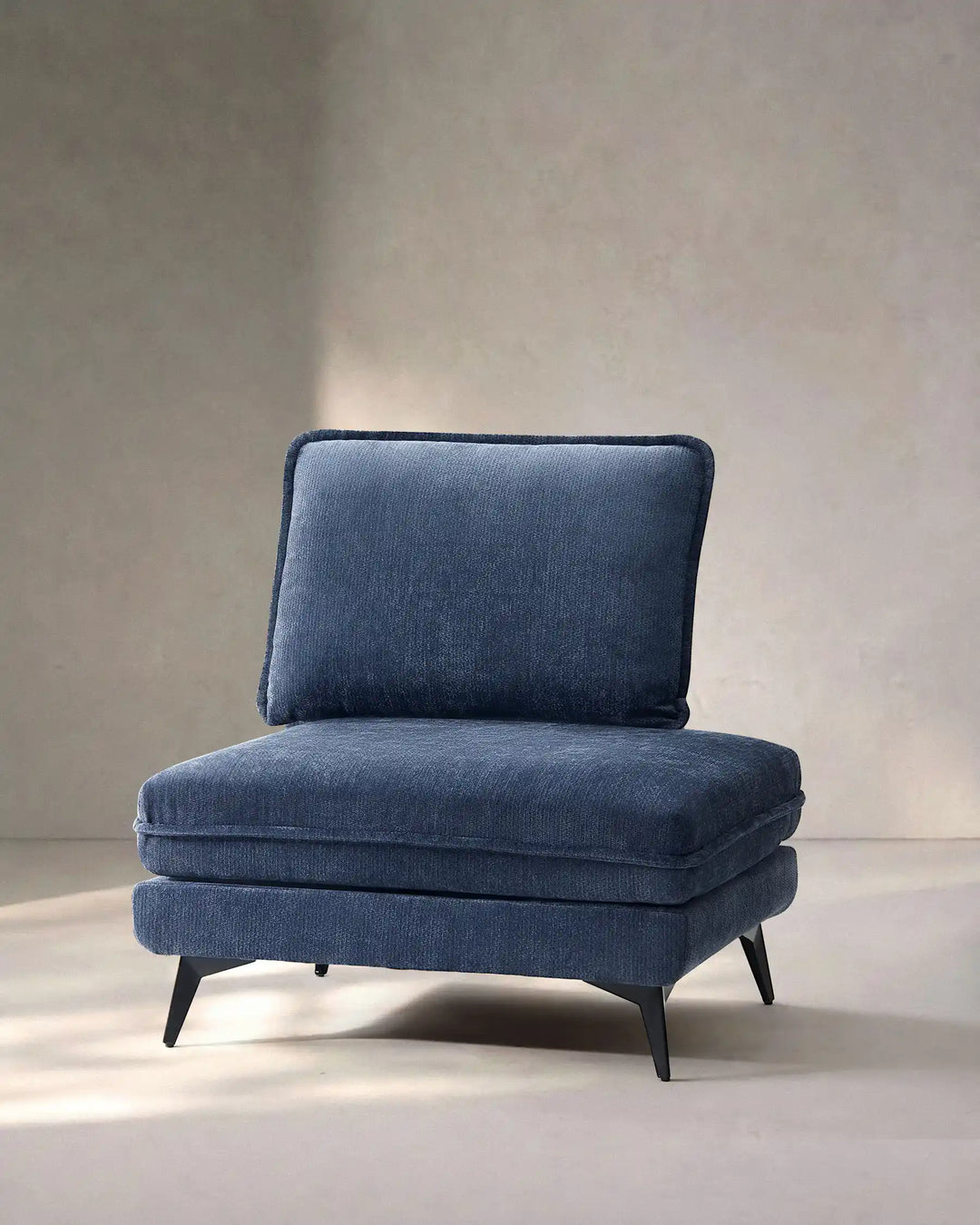 Hudson blue modular sofa (right) on white background showing side view