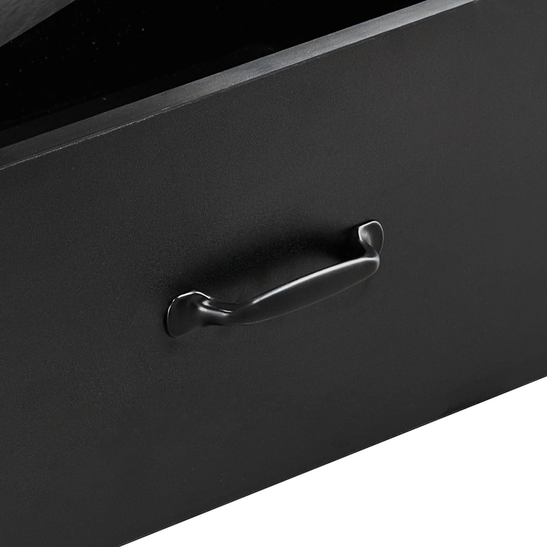 Close-up of black curved metal drawer handle on Kamai black chest of drawers