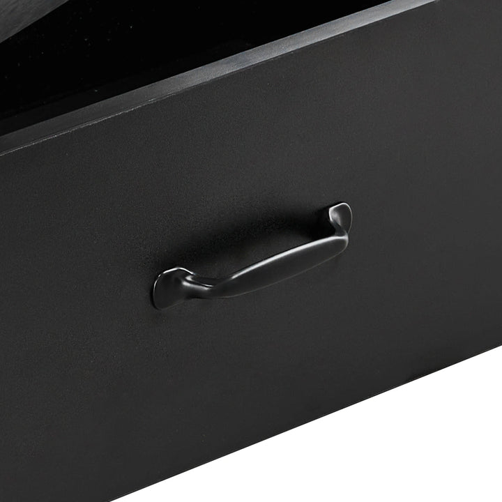 Close-up of black curved metal drawer handle on Kamai black chest of drawers