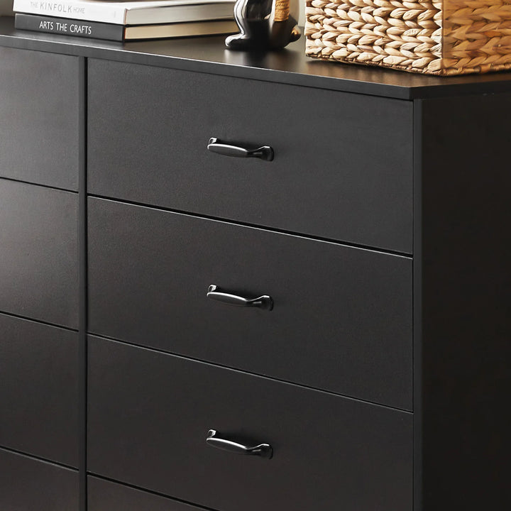 Close-up of Kamai black chest of drawers showing wood grain surface and black curved metal handles