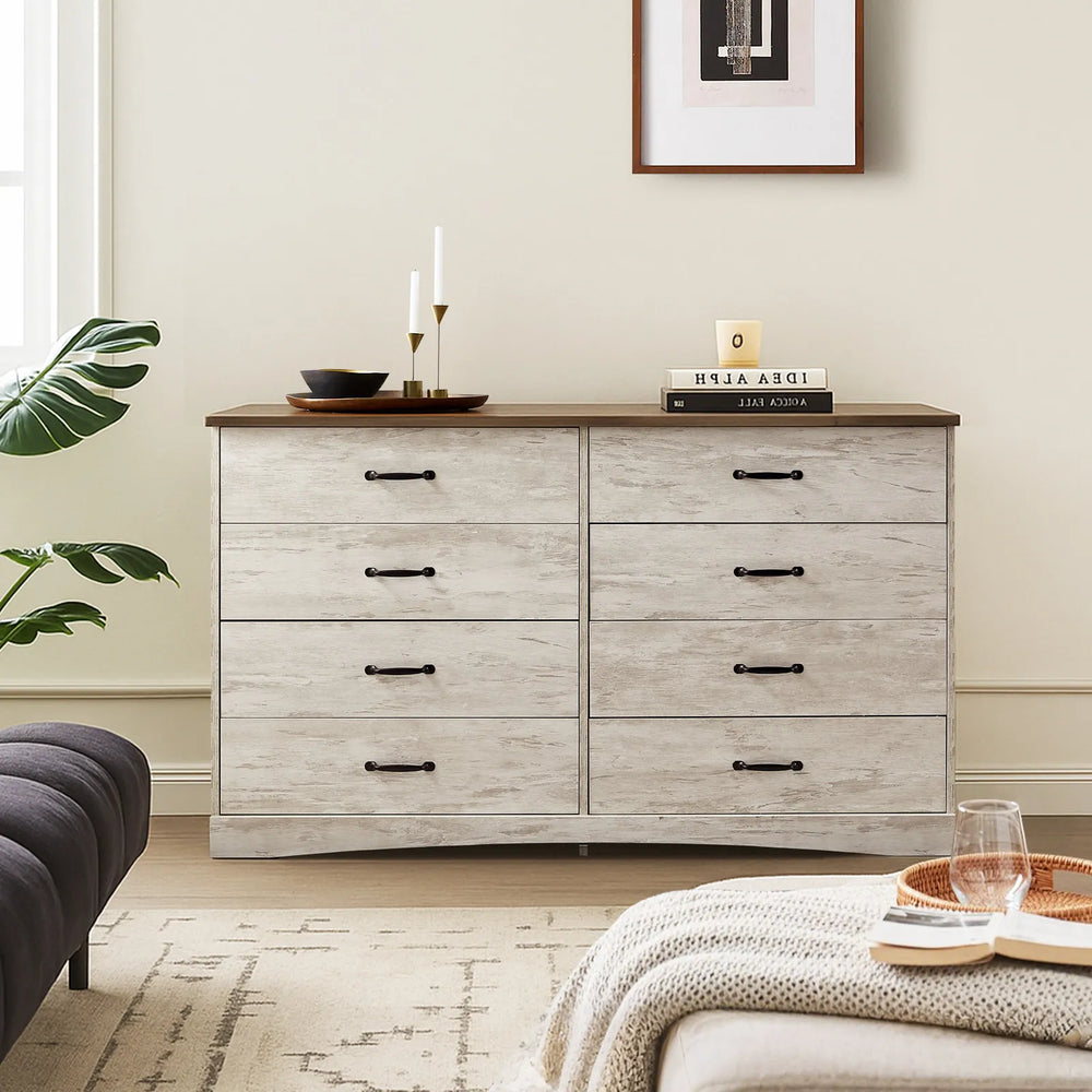 The Kamai rustic grey chest of drawers in the living room, 140cm top surface, displays plates, candles, books, and decor pieces.