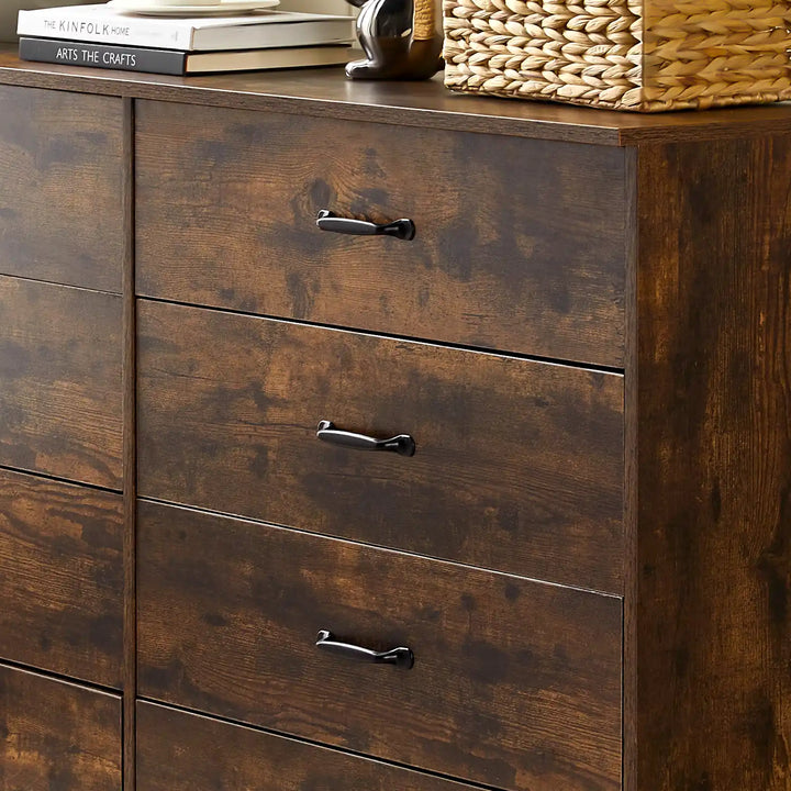 Close-up of Kamai rust brown chest of drawers showing wood grain surface and black curved metal handles.