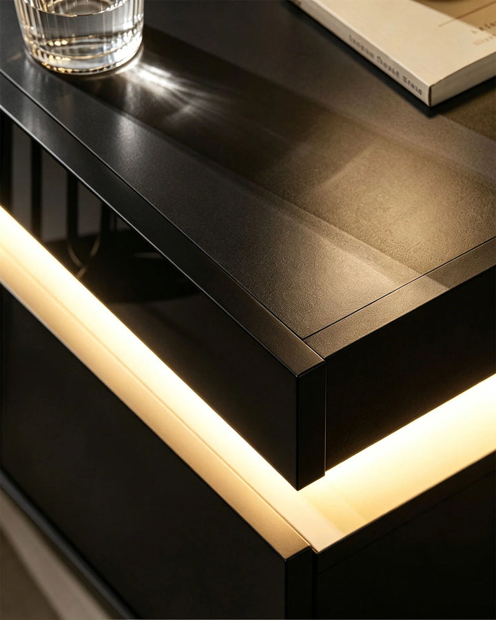 Close-up of the glowing LED strip against the black high gloss finish of the side table.