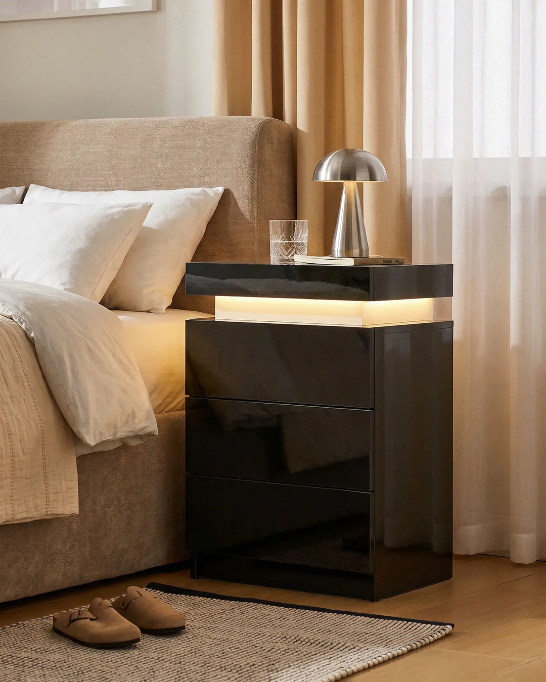 Modern black high gloss smart bedside table with warm LED lighting for bedroom decor.