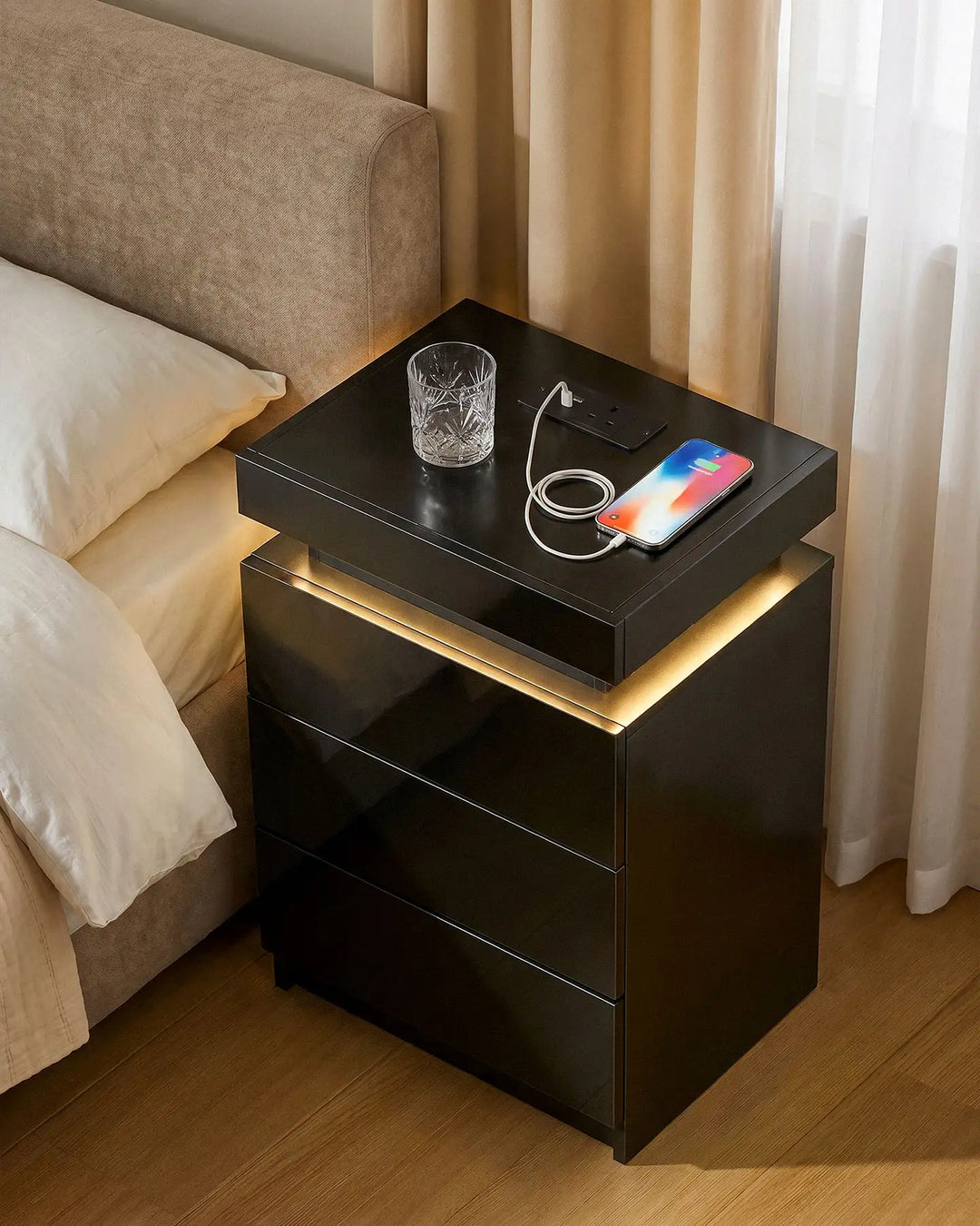Top view of the black bedside table showing space for charging phones and essentials.