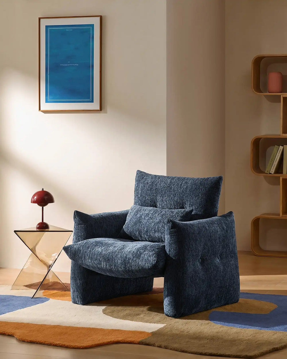 Navy Blue Kumo Accent Chair in a cosy reading corner with soft chenille upholstery and sculptural design