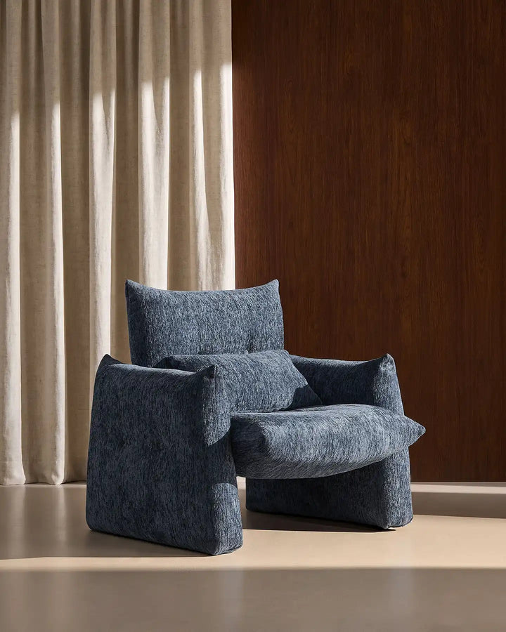 Rear side view of the Navy Blue Kumo Accent Chair showcasing its soft curved contemporary silhouette