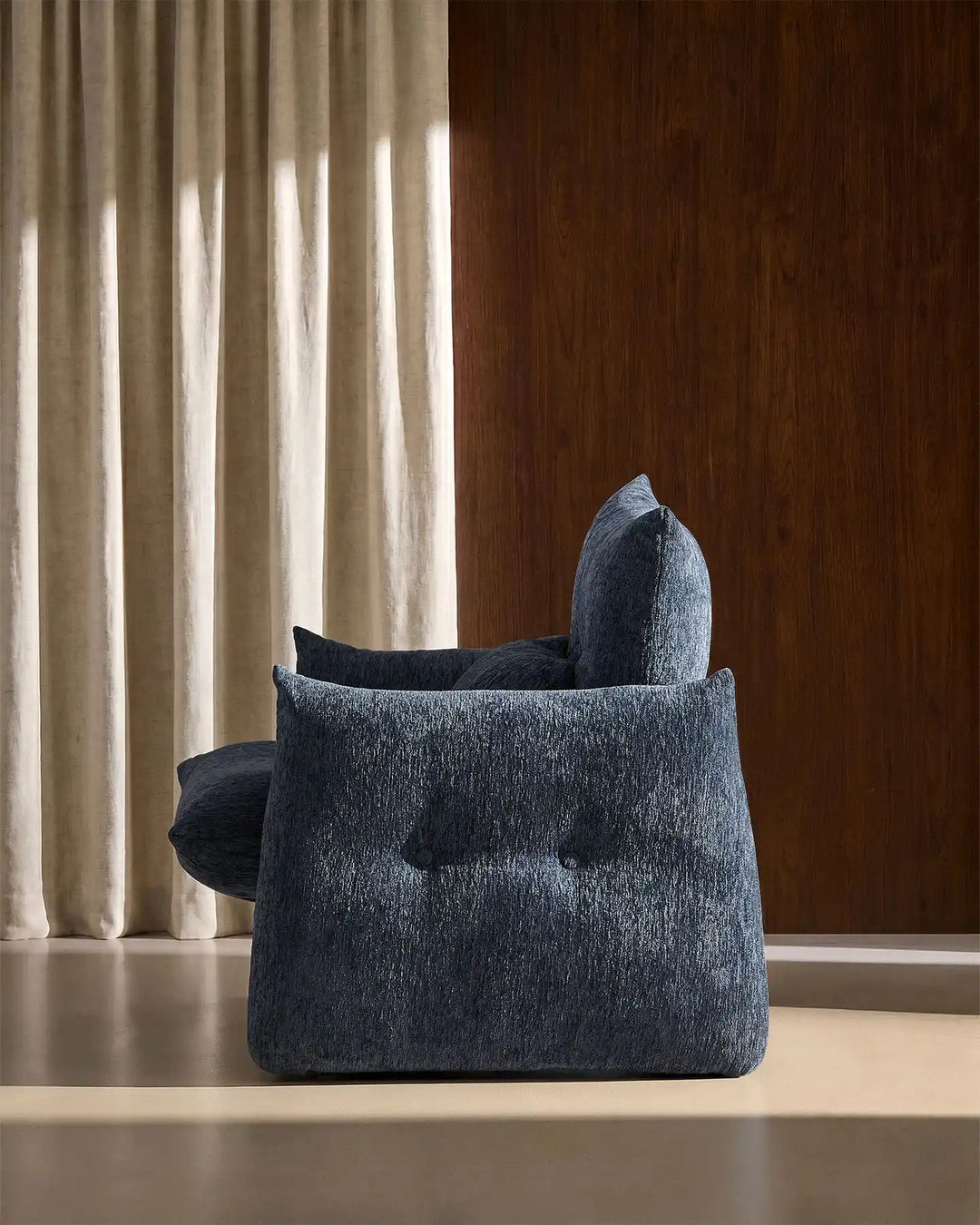 Side profile of the Navy Blue Kumo Accent Chair featuring oversized comfort and rounded modern styling