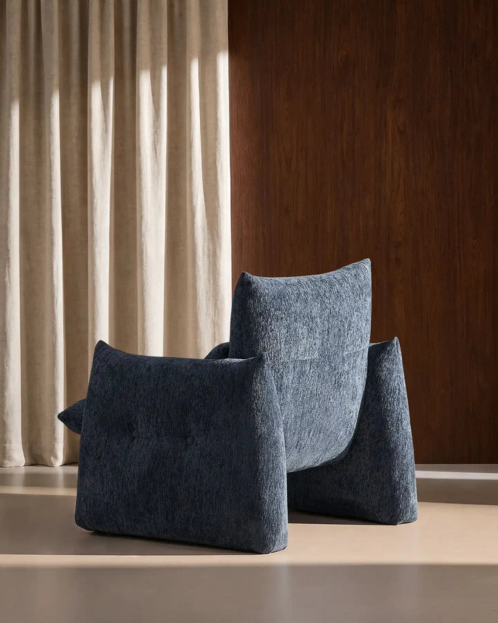 Rear side view of the Navy Blue Kumo Accent Chair showcasing its soft curved contemporary silhouette