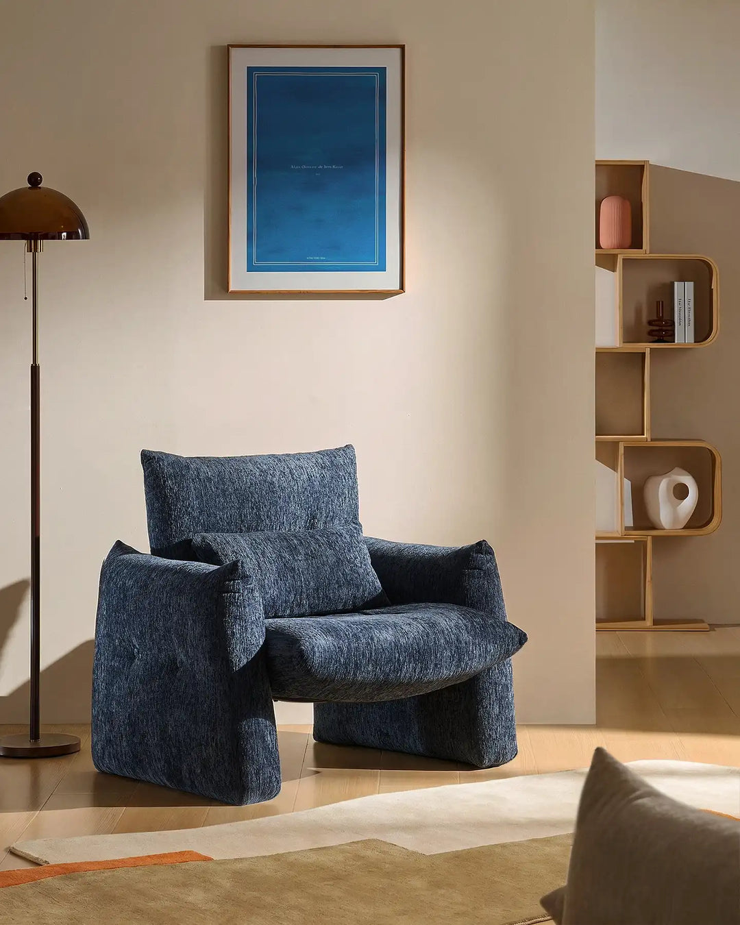 Navy Blue Kumo Accent Chair in a cosy reading corner with soft chenille upholstery and sculptural design