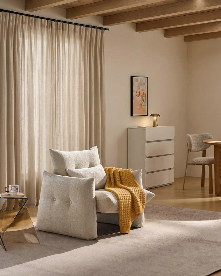 Cream Kumo Accent Chair used as a stylish occasional chair alongside a sofa in a modern living room