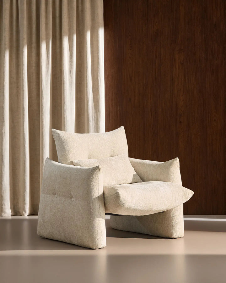 Side profile of the cream Kumo Accent Chair showing its oversized seat and rounded contemporary design