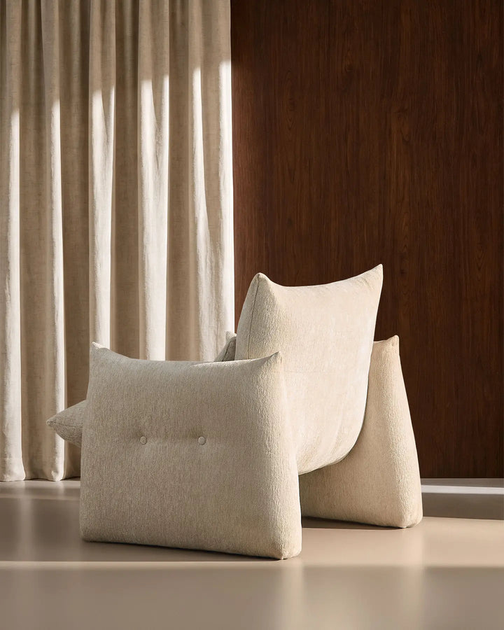 Rear side view of the cream Kumo Accent Chair highlighting its sculptural curved silhouette
