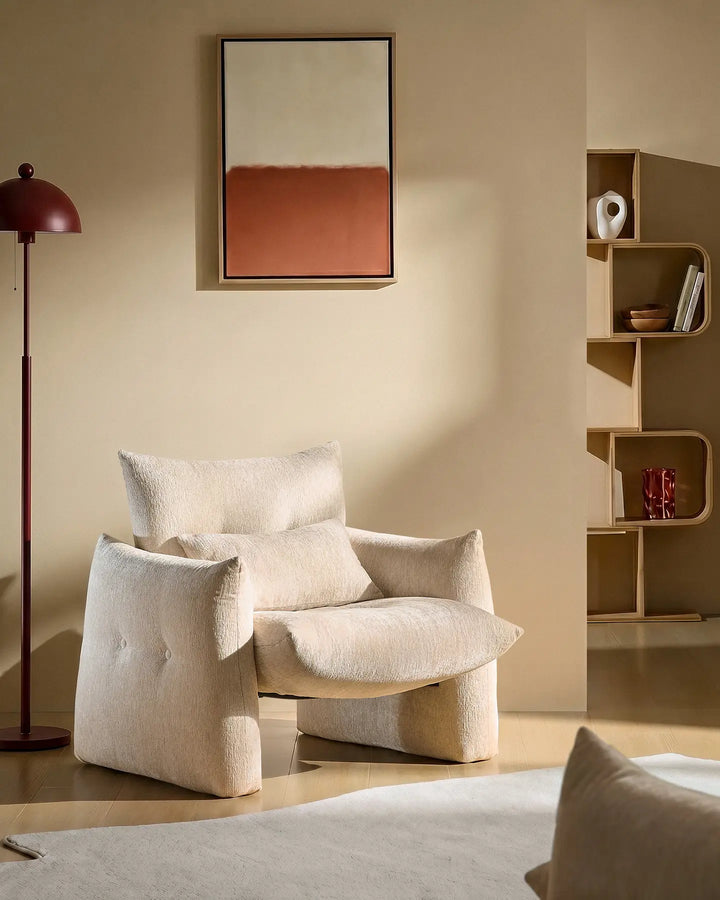 Cream Kumo Accent Chair in a cosy reading corner with soft chenille upholstery and sculptural modern design
