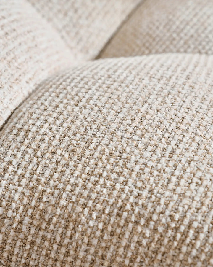Close-up of the Liora beige swivel vanity stool upholstery showing the woven textured fabric and soft neutral beige tone
