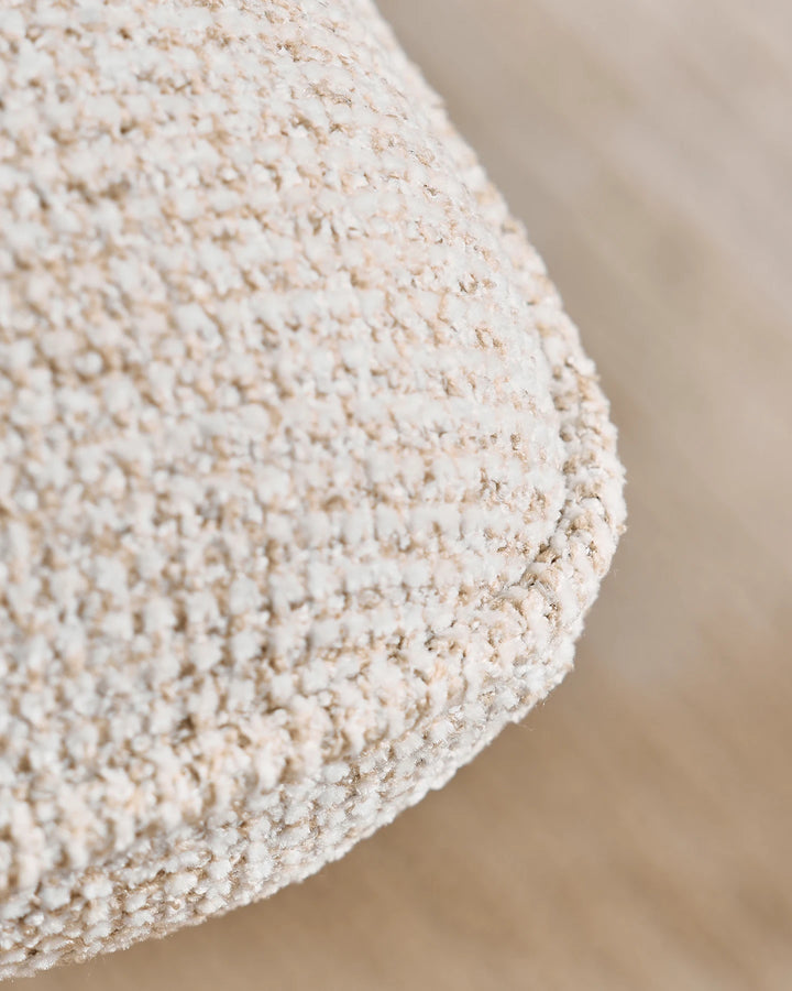Detailed view of the textured beige upholstery on the Liora swivel vanity stool, highlighting its tactile woven finish