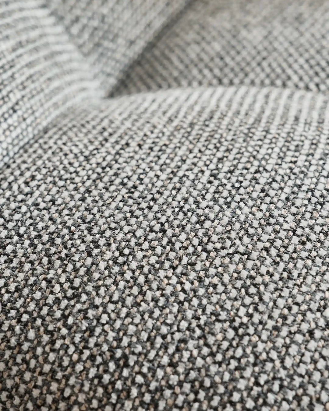 Close-up of the Liora beige swivel vanity stool upholstery showing the woven textured fabric and soft neutral beige tone