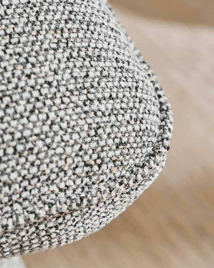 Detailed view of the textured grey upholstery on the Liora swivel vanity stool, highlighting its tactile woven finish