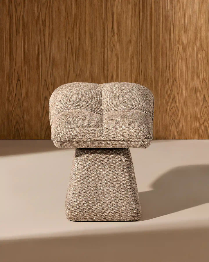 Front view of the Liora khaki swivel vanity stool showing its softly curved padded seat, textured upholstery and sculptural tapered base