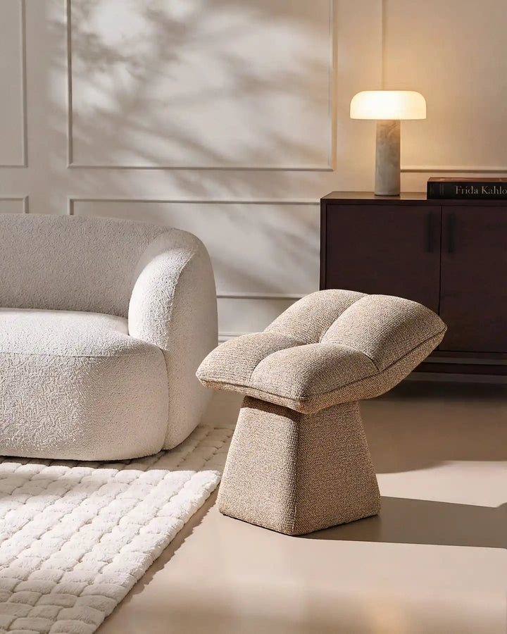 Liora khaki swivel vanity stool paired with a curved upholstered chair and rug in a contemporary neutral living space