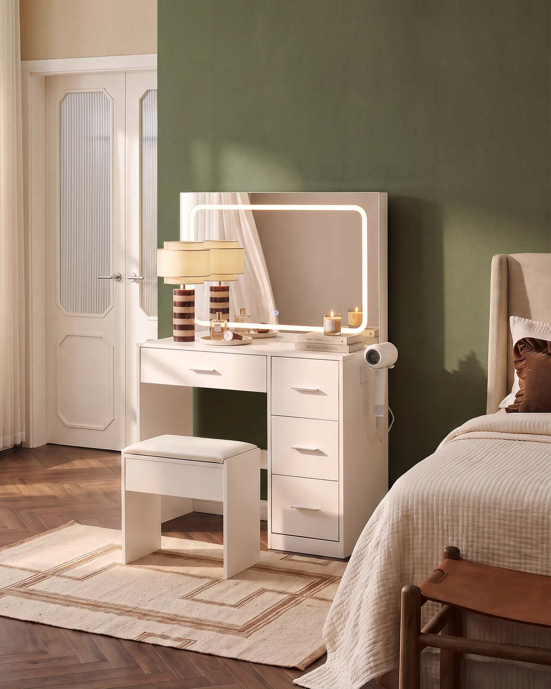 Luna white dressing table set with illuminated mirror and matching stool, styled beside a bed in a contemporary neutral bedroom.
